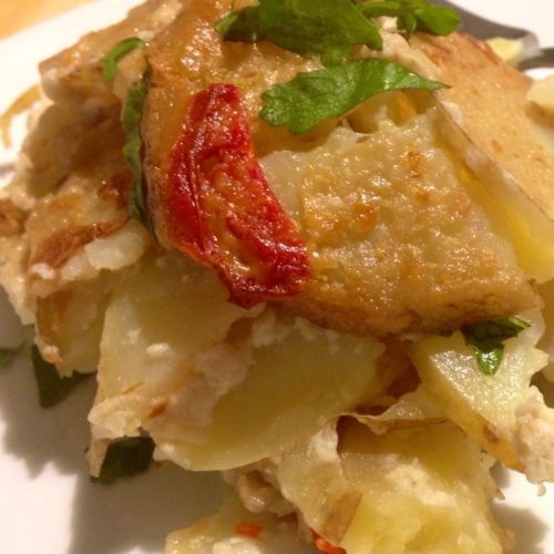 Tom Kha scalloped potatoes on white plate