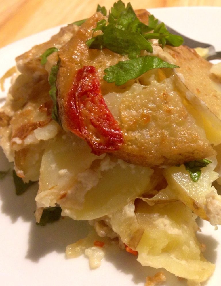 Tom Kha scalloped potatoes on white plate