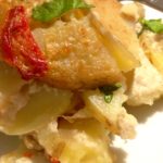 A close up of gluten-free scalloped potatoes on a plate.