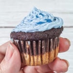 Hand holding an almond flour cupcake.