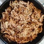 Overhead shot of paleo carnitas in a cast iron skillet.