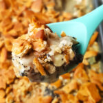 Spoon lifting out dairy free poppy seed chicken casserole.