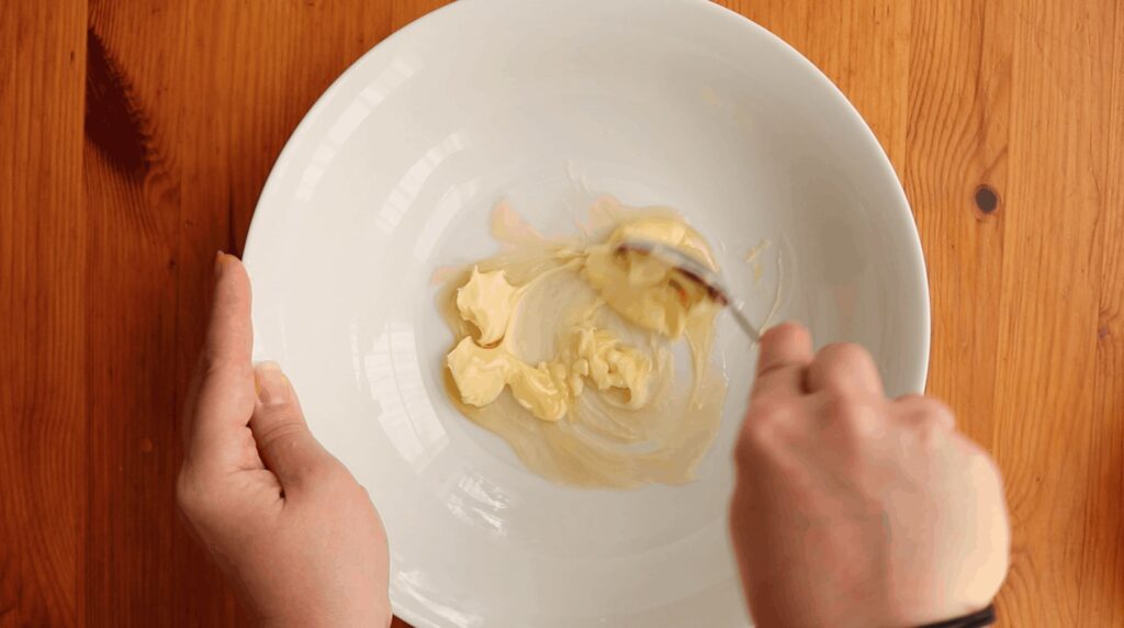 mixing honey and butter in a bowl