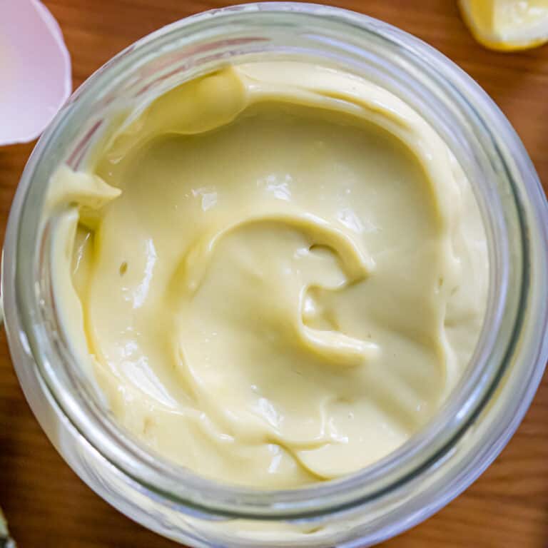 Overhead shot of keto mayonnaise surrounded by ingredients.