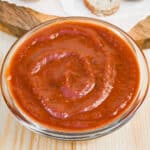 Ketchup in a small glass bowl.