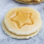 A pile of keto dalgona candies on parchment paper.