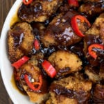 Overhead shot of paleo orange chicken in a white bowl.