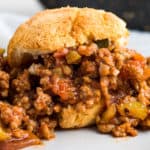 Keto sloppy joes in a bun on a grey plate.