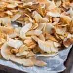 Toasted coconut flakes on a baking sheet.