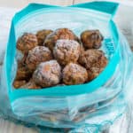 Frozen meatballs in a plastic bag on a table.