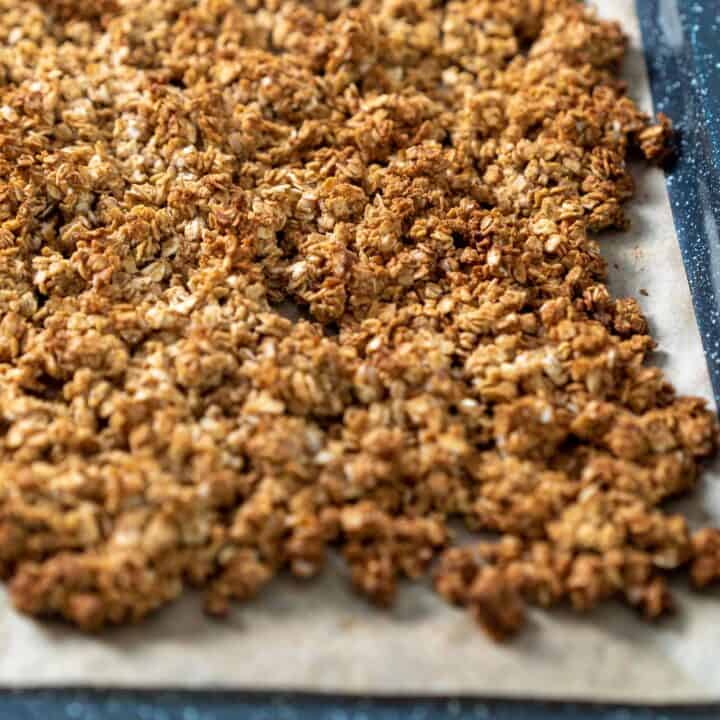 A pile of granola on a baking sheet.