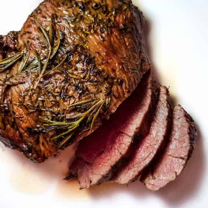 A plate of eggplant pizza with pepperoni and pepper slices.