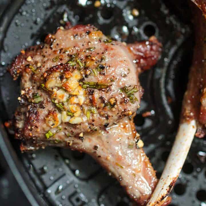 A piece of meat with spices on it.