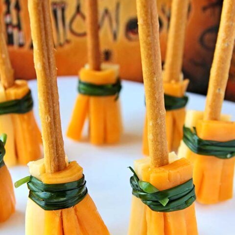 A plate with cheese sticks and a broom.