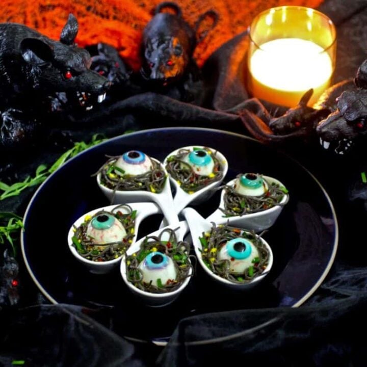 A plate of halloween treats with a candle on it.