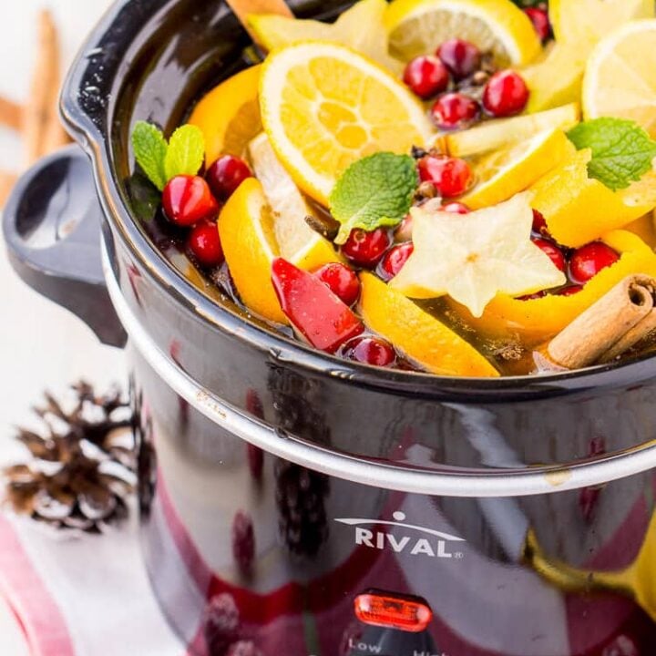 A Christmas crock pot simmer pot filled with fruit and spices.
