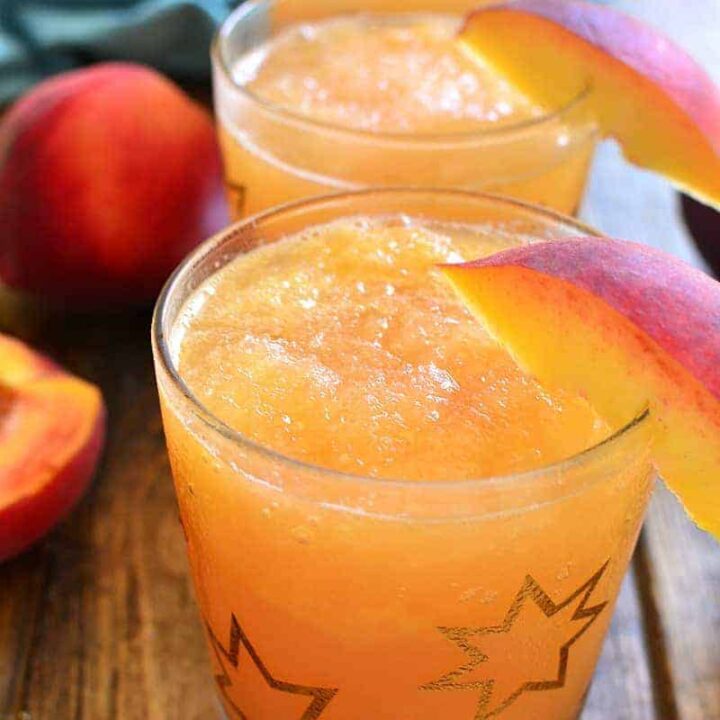 Virgin Piña coladas on a grey table with pineapple in the background.