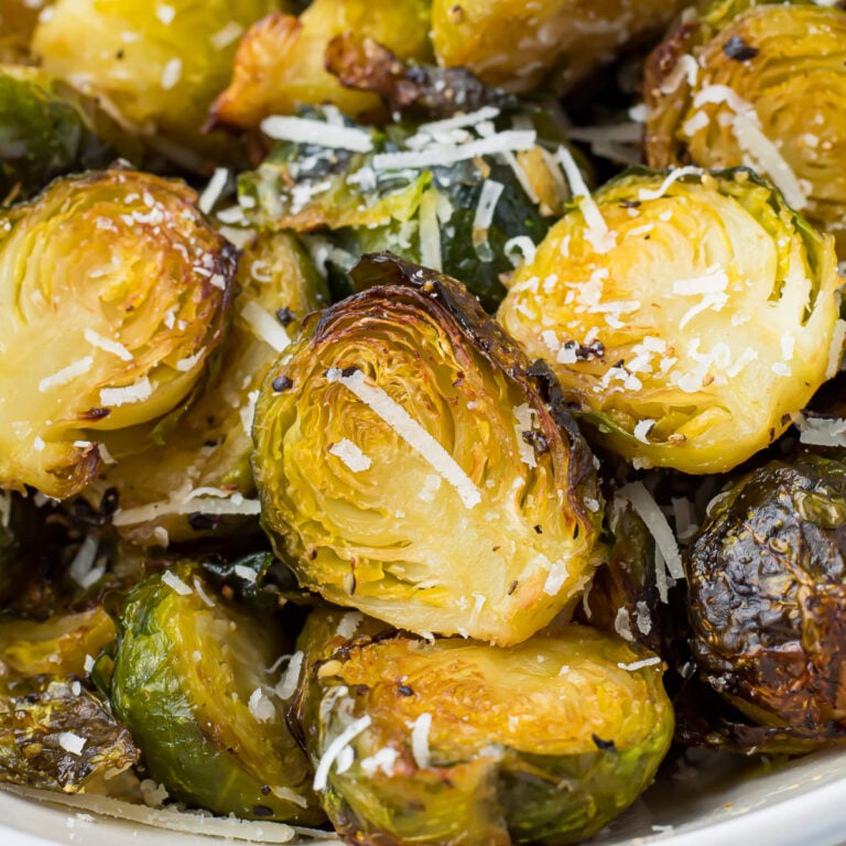 Close up of air fryer brussels sprouts in a white bowl.