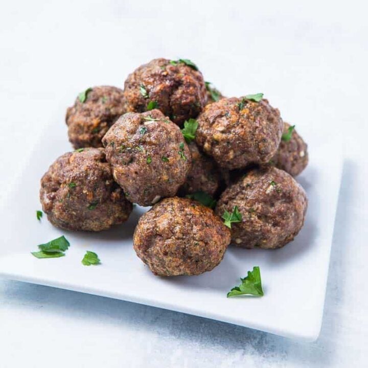 Crispy Meatballs on a white plate cooked using an air fryer.