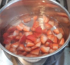 Strawberries in a pot of water.