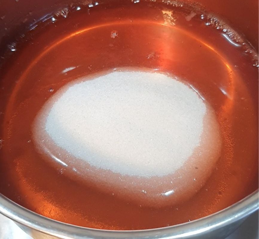 Sweetener in a pot of strawberry water.