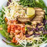 Cheeseburger bowl in a white bowl on a white table with a white cloth.