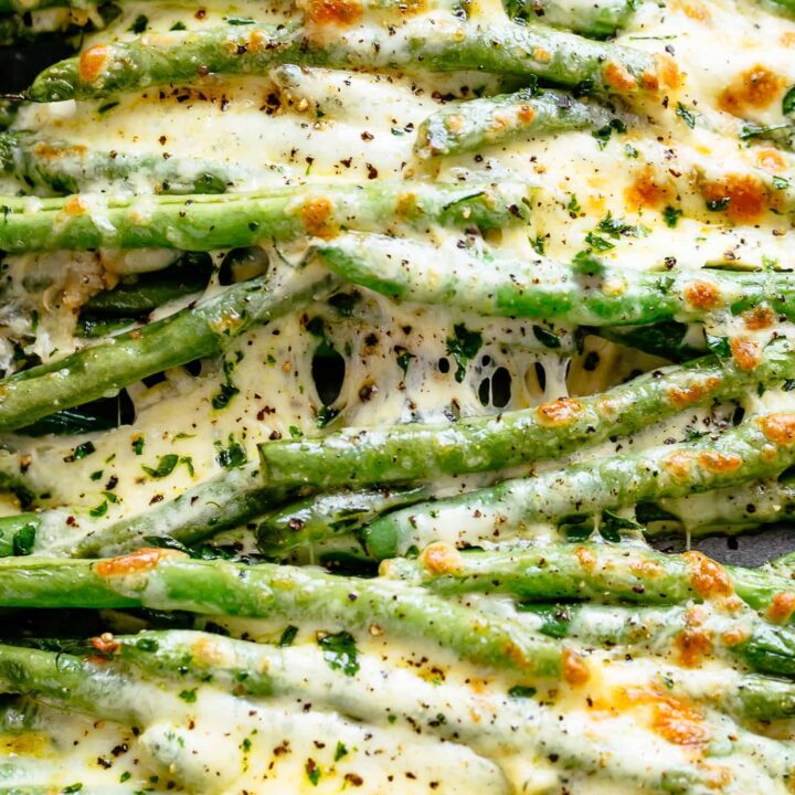 Low Carb Cheesy green beans in a baking dish with a spatula.