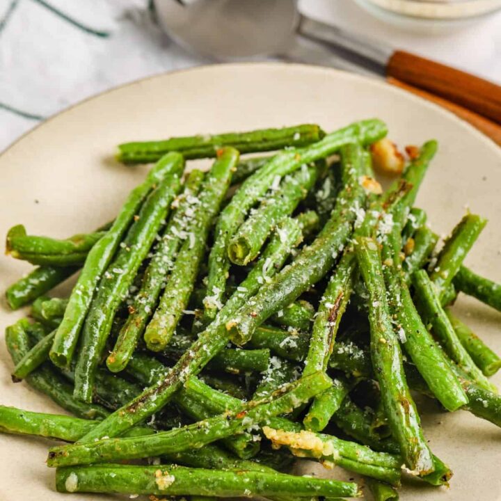 Low Carb Thanksgiving Side Dish: Green beans with parmesan on a plate.