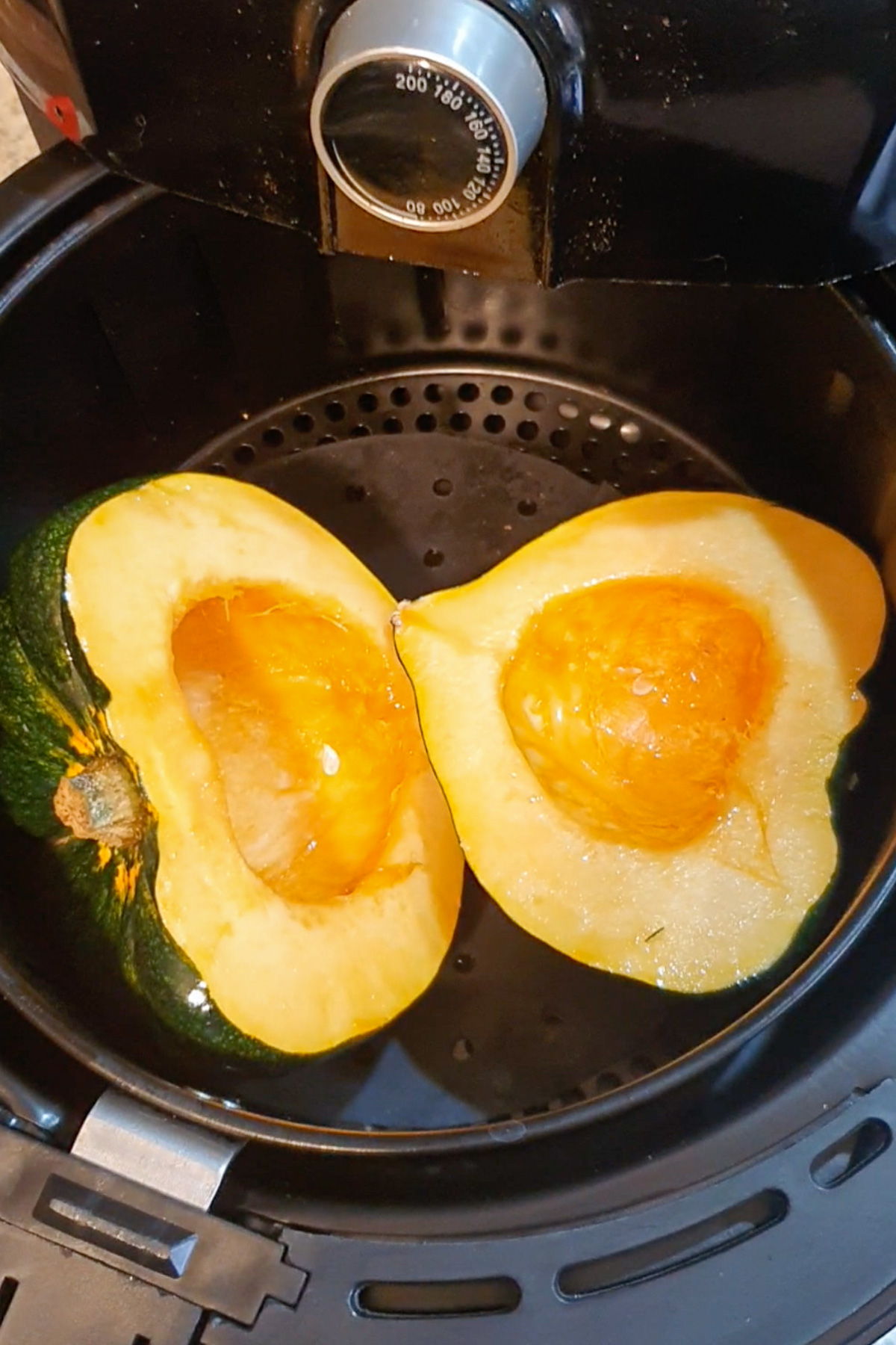 Raw acorn squash in an air fryer.