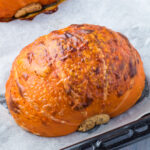 A roasted pumpkin on a baking sheet.