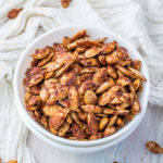 Sweet roasted pumpkin seeds in a white bowl.