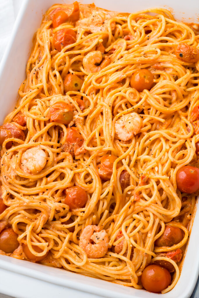 Shrimp feta pasta served in a white baking dish.