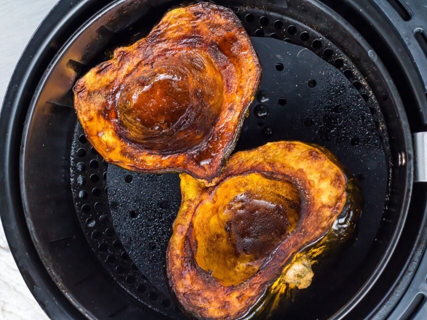 Two roasted squash in an air fryer.