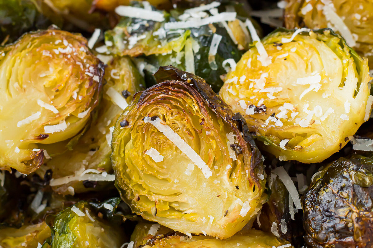 Close up of air fryer brussels sprouts in a white bowl.