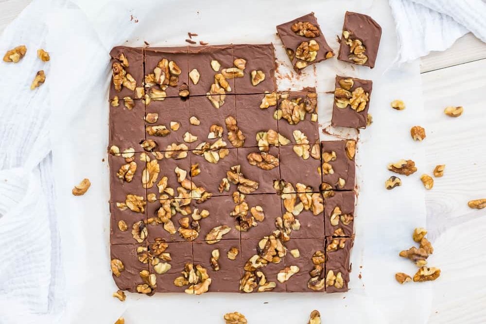 A keto-friendly square of chocolate fudge with walnuts on top.