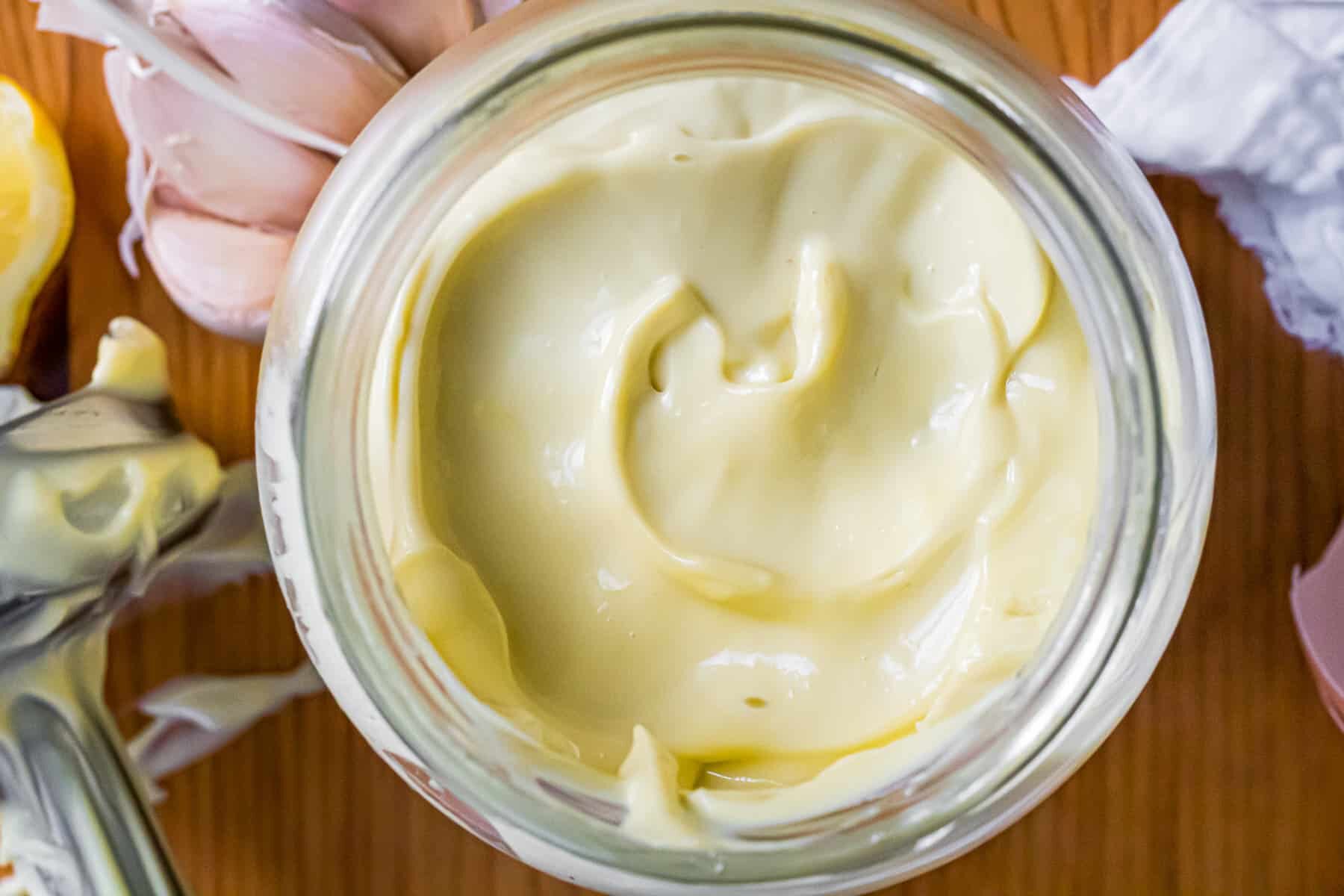 Overhead shot of keto mayonnaise surrounded by ingredients.