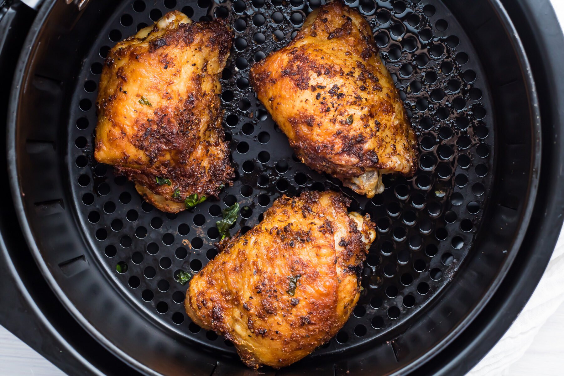 Leftover chicken thighs in an air fryer.