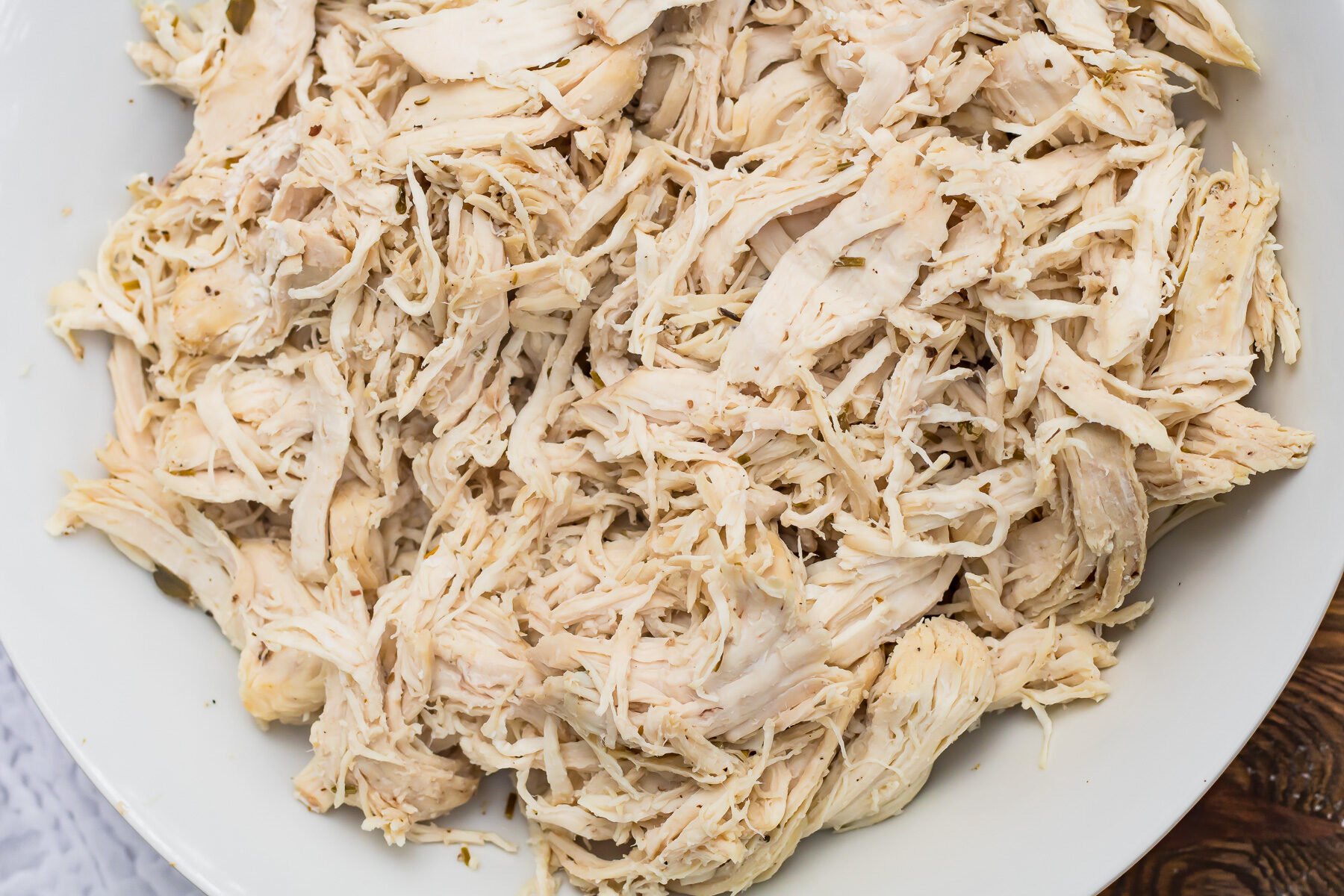 Instant Pot Shredded Chicken served in a white bowl on a table.
