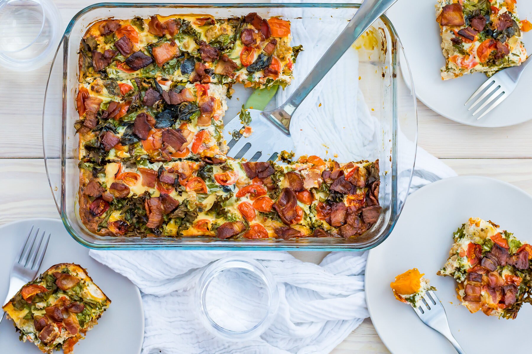 A whole30 breakfast casserole dish with a slice taken out of it.