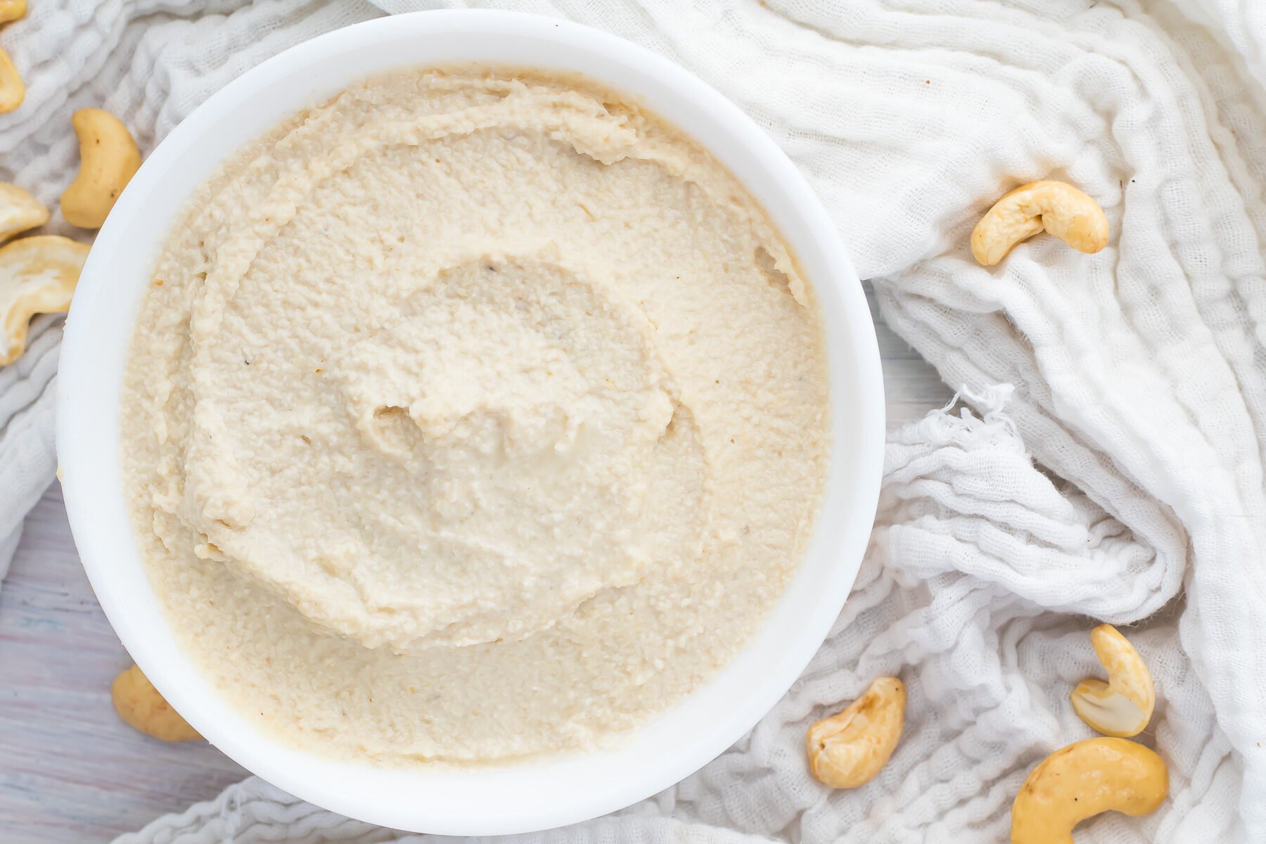 Overhead photo of whole30 cashew cream cheese in a white bowl.