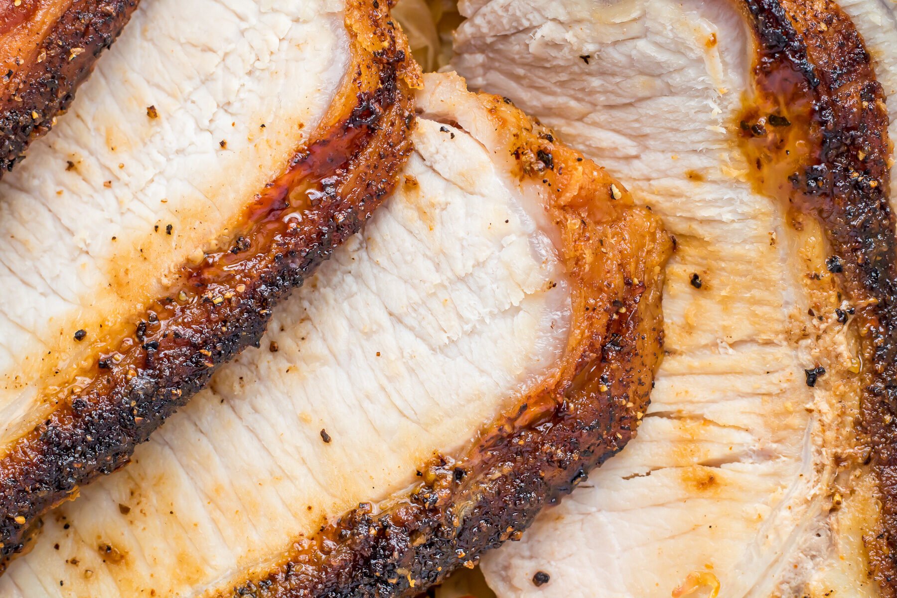 Close up of air fryer pork loin roast slices.