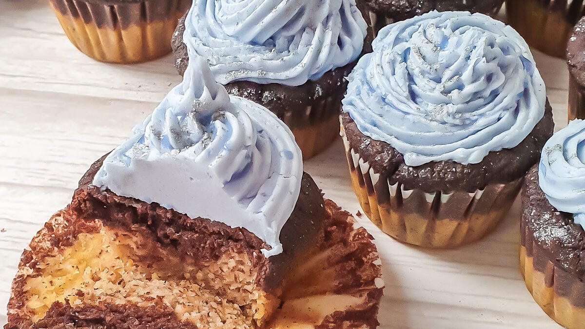 Gluten free cupcakes with almond flour on a table, one cut in half.