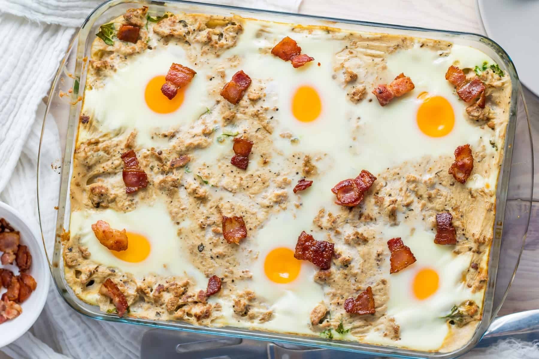 A casserole dish filled with eggs and bacon.