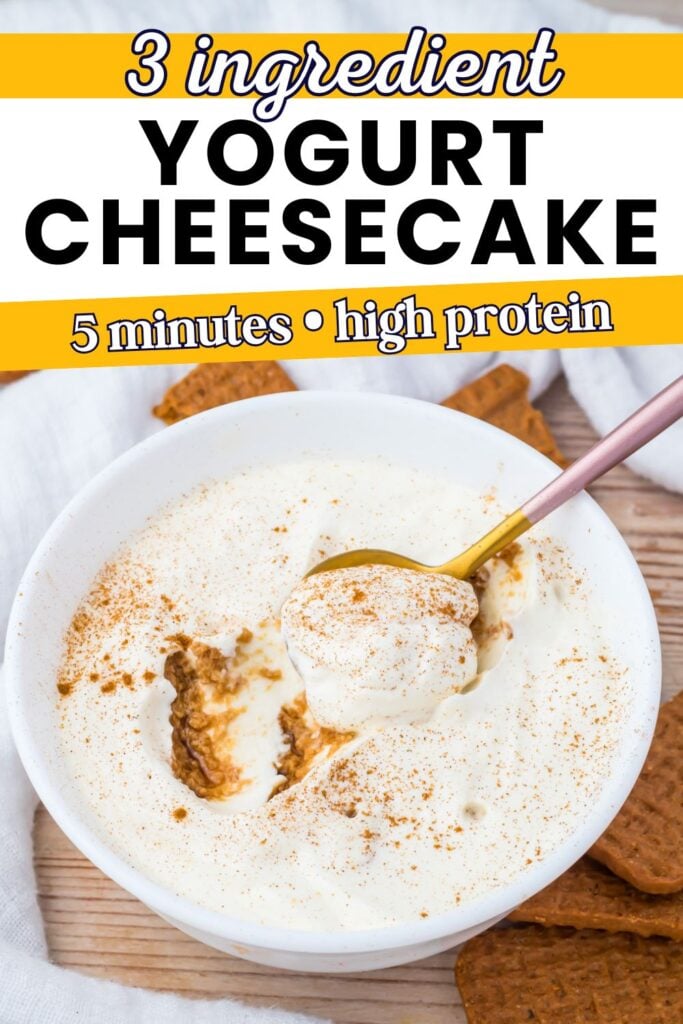 A bowl of 3 ingredient yogurt cheesecake topped with cinnamon, with a spoon and several biscoff cookies on the side. Text reads: “3 ingredient yogurt cheesecake, 5 minutes, high protein.”.